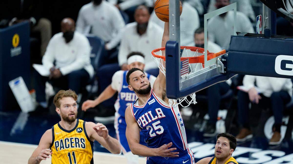 Philadelphia 76ers’ Ben Simmons (25) dunks against Indiana Pacers’ Domantas Sabonis (11) during the first half of an NBA basketball game, Tuesday, May 11, 2021, in Indianapolis. (AP Photo/Darron Cummings)