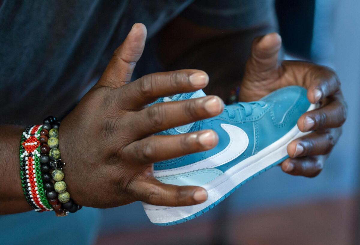 Berry Accius, founder of Voice of the Youth and community activist, shows his team what kind of shoes he would like to get for the shoe drive at Sheikh on Wednesday, July 21, 2021. This is Voice of the Youth’s the first shoe drive and will occur on Sunday from 11 a.m. to 3 p.m. at Hidden Gems Thrift Store.