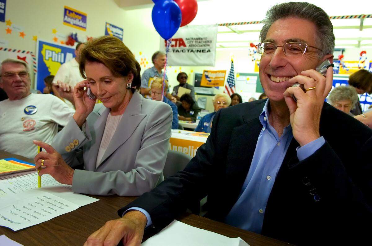 House Minority Leader Nancy Pelosi and California Treasurer Phil Angelides, who is running for governor, call supporters at a phone bank at the Sacramento City Teachers Association on Oct. 18, 2006.