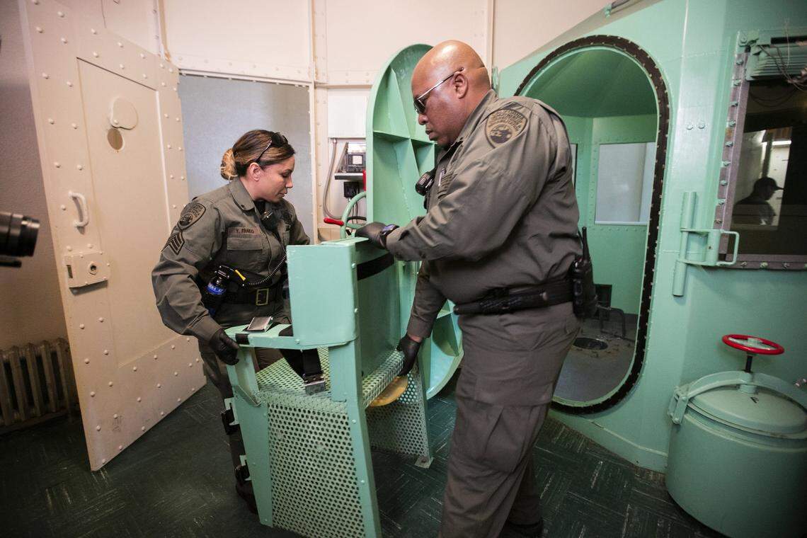 In this photo provided by the California Department of Corrections and Rehabilitation a chair is removed from the death penalty chamber at San Quentin State Prison, Wednesday, March 13, 2019, in San Quentin, Calif. Gov. Gavin Newsom signed an executive order, Wednesday, placing a moratorium on the death penalty. (California Department of Corrections and Rehabilitation via AP)