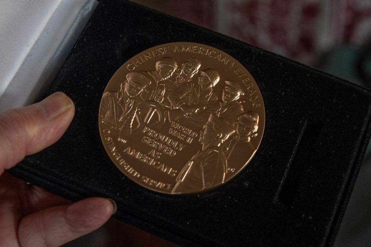 Ken Mar, 95, holds his Congressional Gold Medal at his Sacramento home on Monday. The World War ll veteran fought in the infantry on the front lines in Europe.