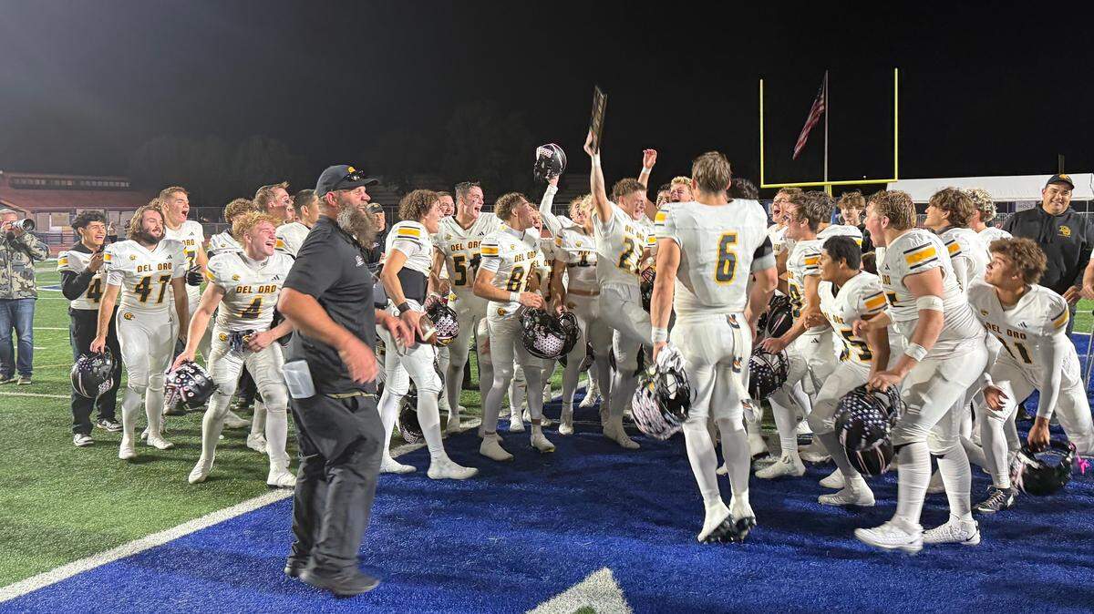 Del Oro coach Josh Parry, left, celebrates with his Golden Eagles team after a 15-14 win over rival Rocklin for the Battle of the Shield honor Friday at Rocklin High School.