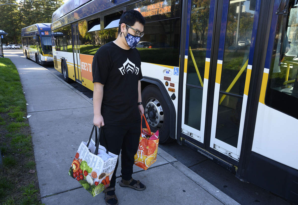 Jordan Yang, 19, carries groceries after shopping at a nearby grocery store, a bus ride away from his Pocket area apartment on Nov. 19. Aspiranet is asking Book of Dreams readers for donations to purchase metal grocery carts for their clients who don’t have cars. 