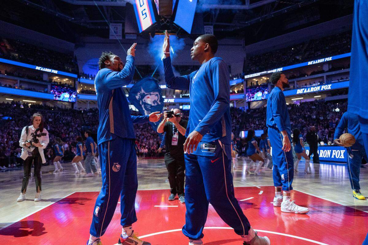 Sacramento Kings guard Malik Monk, left, and teammate De’Aaron Fox high-five before a 2024 game against the Memphis Grizzlies at Golden 1 Center.