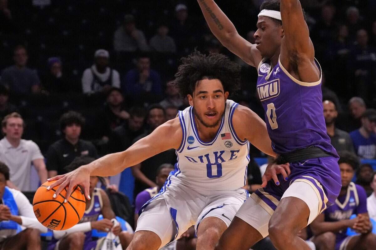 Mar 24, 2024; Brooklyn, NY, USA; Duke Blue Devils guard Jared McCain (0) dribbles the ball past James Madison Dukes guard Xavier Brown (0) in the second round of the 2024 NCAA Tournament  at Barclays Center. Mandatory Credit: Robert Deutsch-USA TODAY Sports