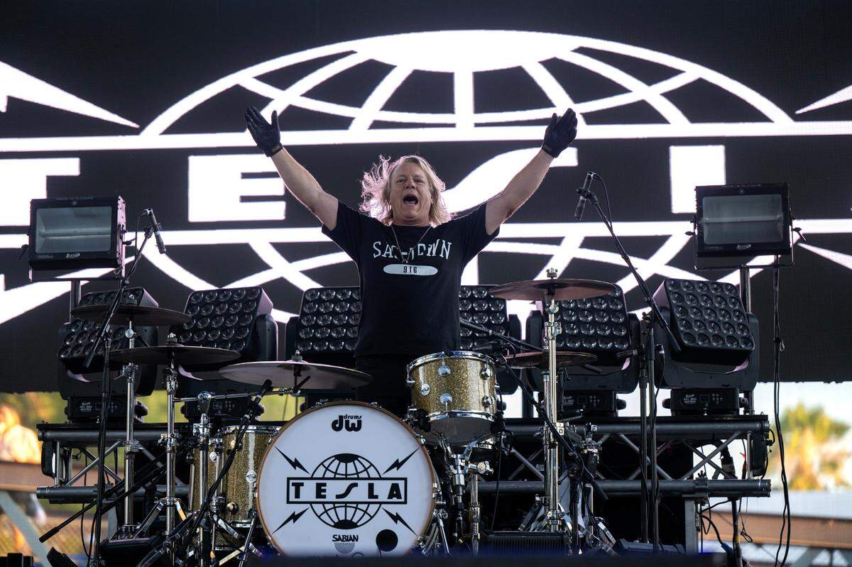 Tesla drummer Steve Brown recognizes the crowd as the band takes the stage at the California State Fair in Sacramento on Friday.