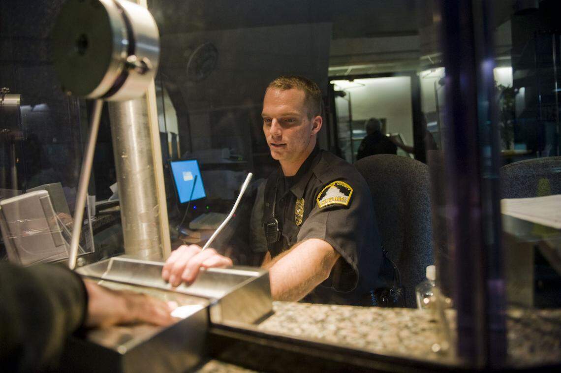 Sheriff’s deputy Matt Carpenter checks the ID of visitors while working security at the Sacramento County Main Jail on 2010.
