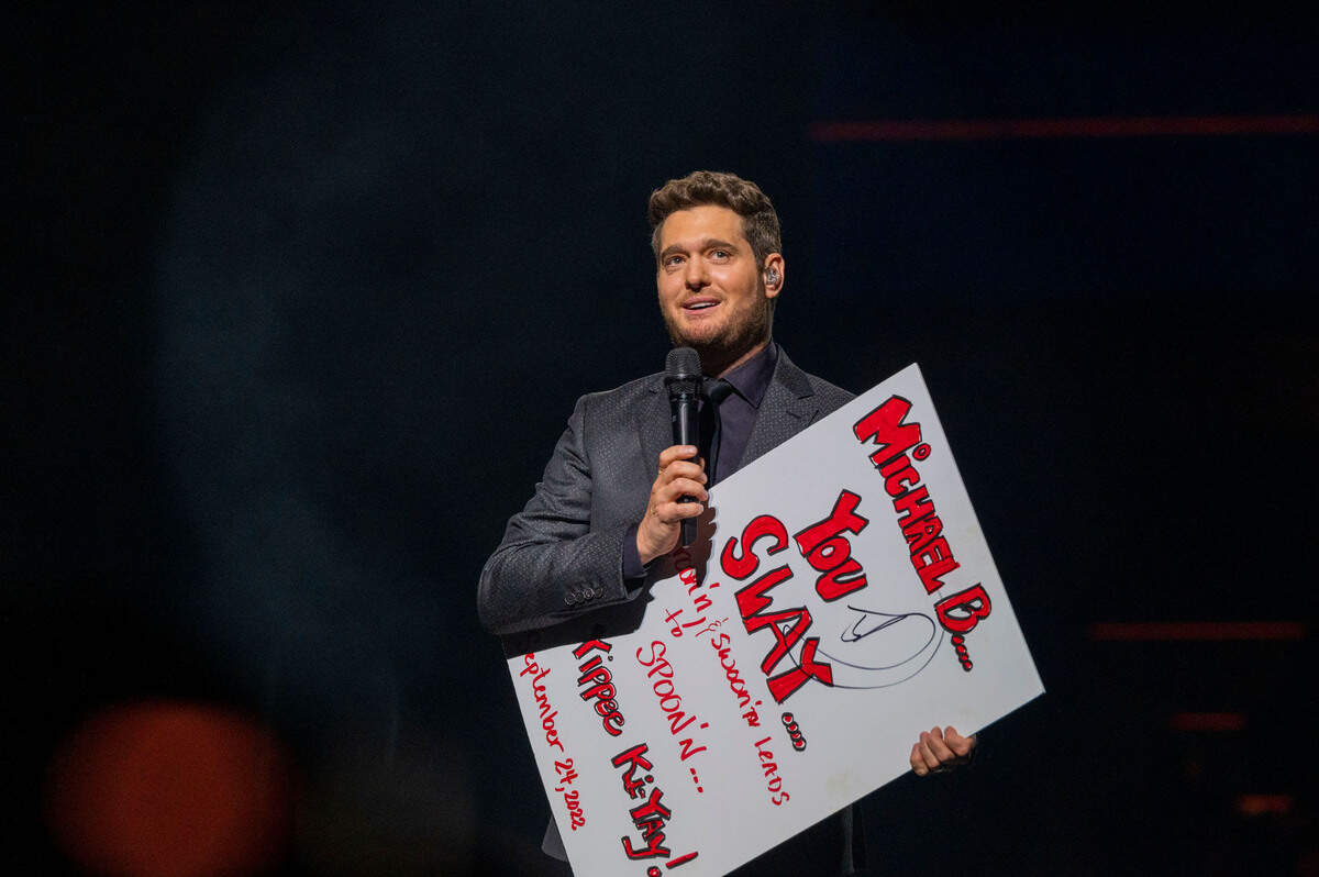 Michael Bublé holds up a sign from a fan that says “Michael B… You Slay … Croon’n and swoon’n leads to spoon’n … Yippee Ki-Yay,” while performing his Higher Tour at Golden 1 Center on Saturday.