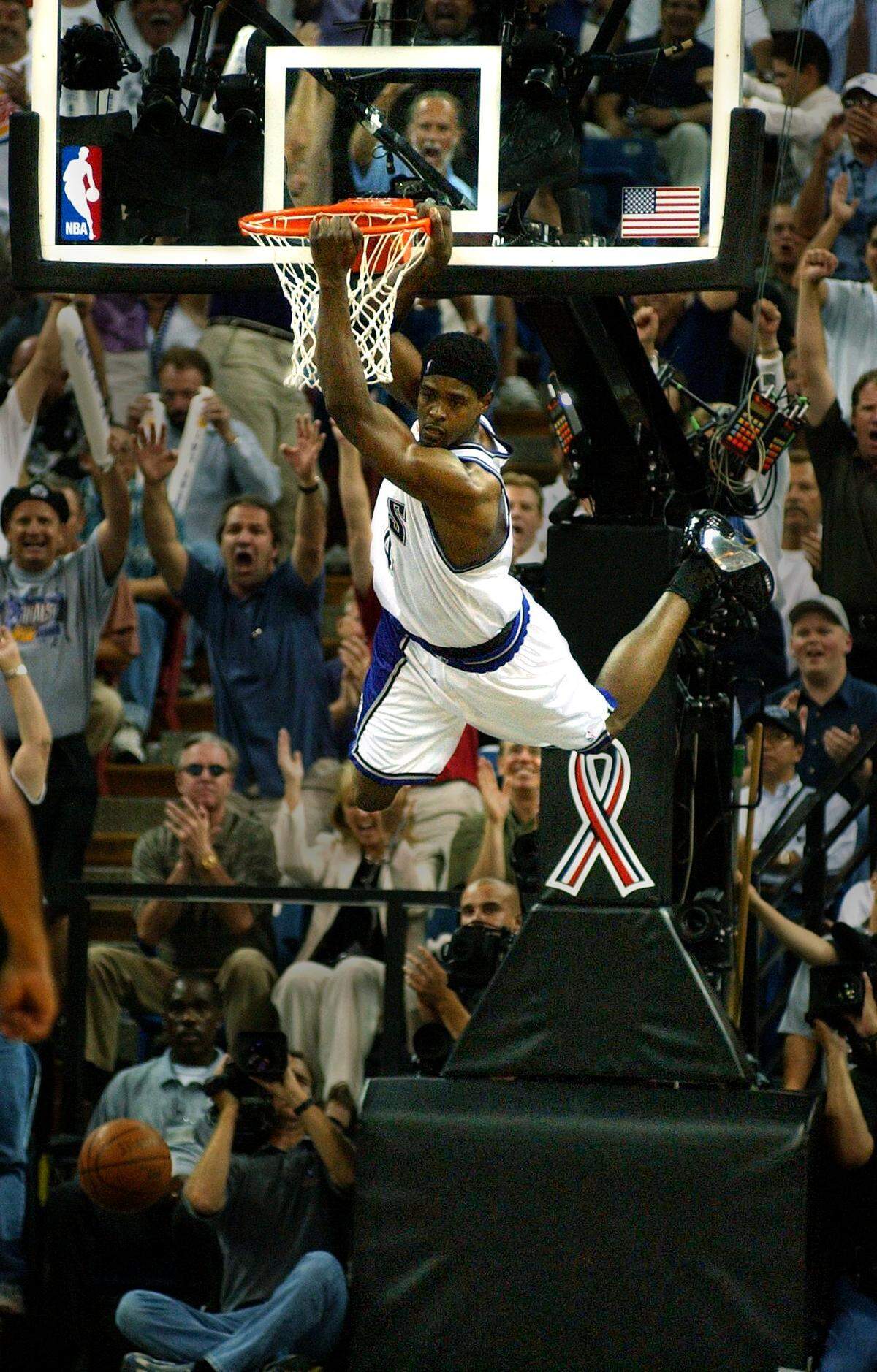 Chris Webber hangs from the rim after a first quarter dunk in Game 5 of the NBA Western Conference Finals between the Sacramento Kings and the Los Angeles Lakers at Arco Arena on May 28, 2002. 