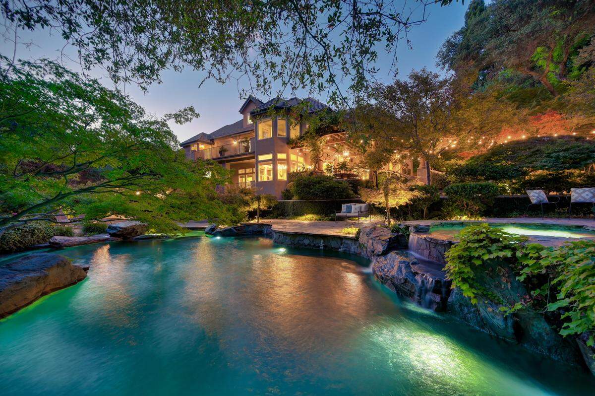 Grand and private: 2471 Loch Way stands on two wooded acres with over 8,000 square feet of luxury living.