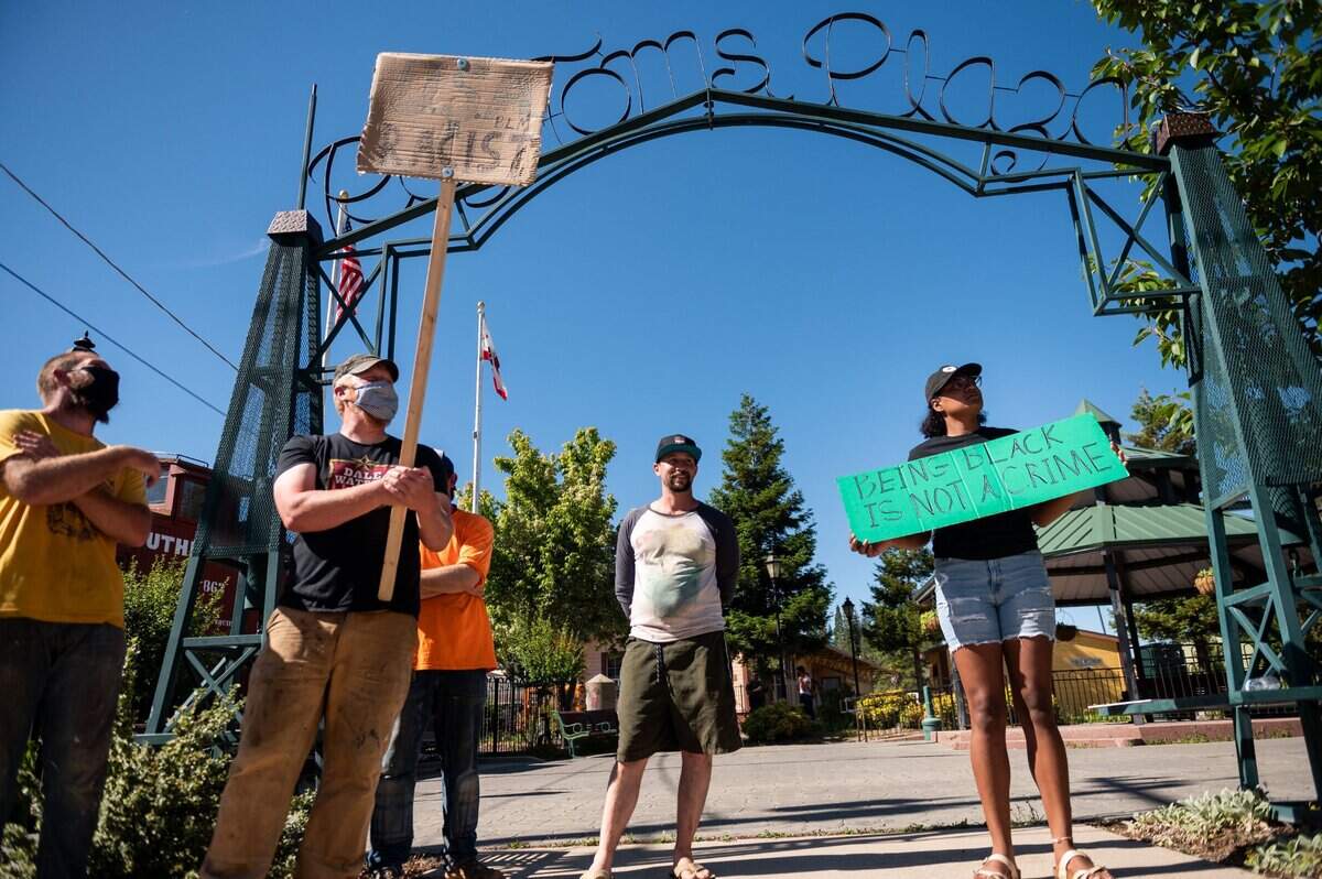 Bennie Nelson, right, of Colfax, gathers with other protesters against racial injustice in Colfax on Wednesday.