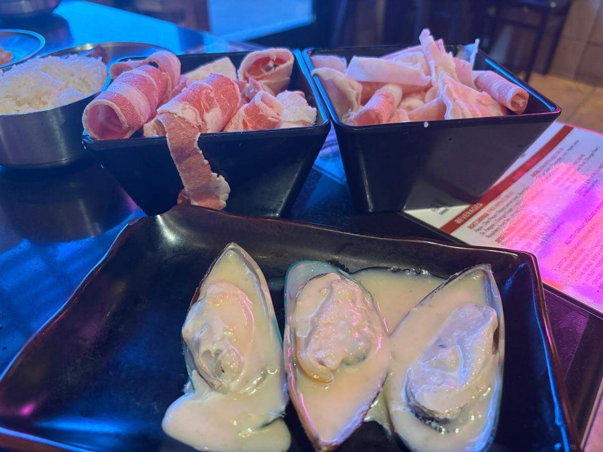 Parmesan mussels, woobaesal and daepae sam-gyup-sal are ready to be cooked over a hot tabletop grill at Oz Korean BBQ in Elk Grove.