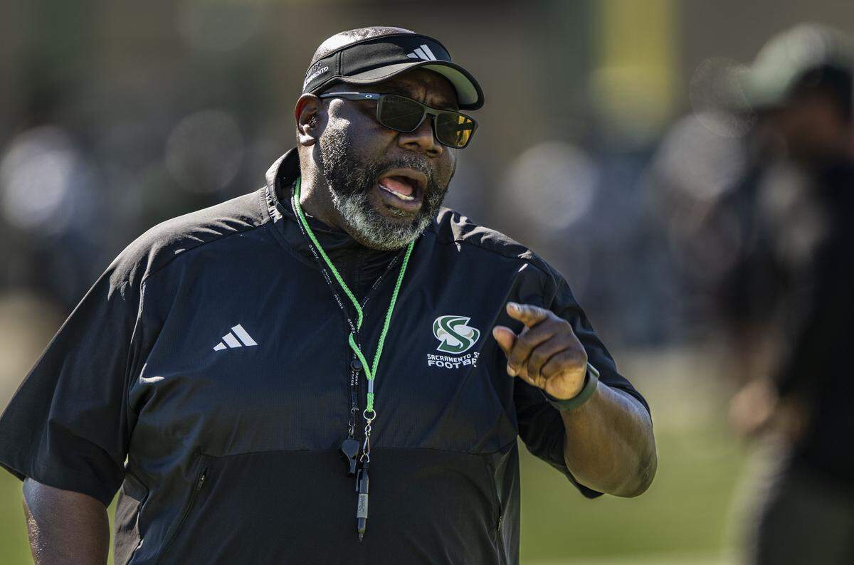 Sacramento State football coach Alonzo Carter calls out his defensive players during spring football drills on Thursday at Hornet Stadium.