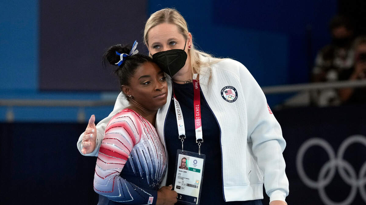 Simone Biles gets a hug from her coach, Cecile Canqueteau-Landi, after competing in the vault on Aug. 3, 2021, in Tokyo.
