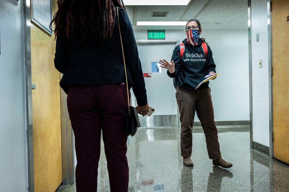 Hedstrom talks to a legislative staffer in the state Capitol on Oct. 18 as she dropped off a letter concerning a transportation bill. Hedstrom said she’s been to the building at least 200 times to protest a range of issues.