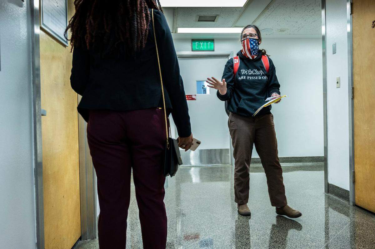 Hedstrom talks to a legislative staffer in the state Capitol on Oct. 18 as she dropped off a letter concerning a transportation bill. Hedstrom said she’s been to the building at least 200 times to protest a range of issues.