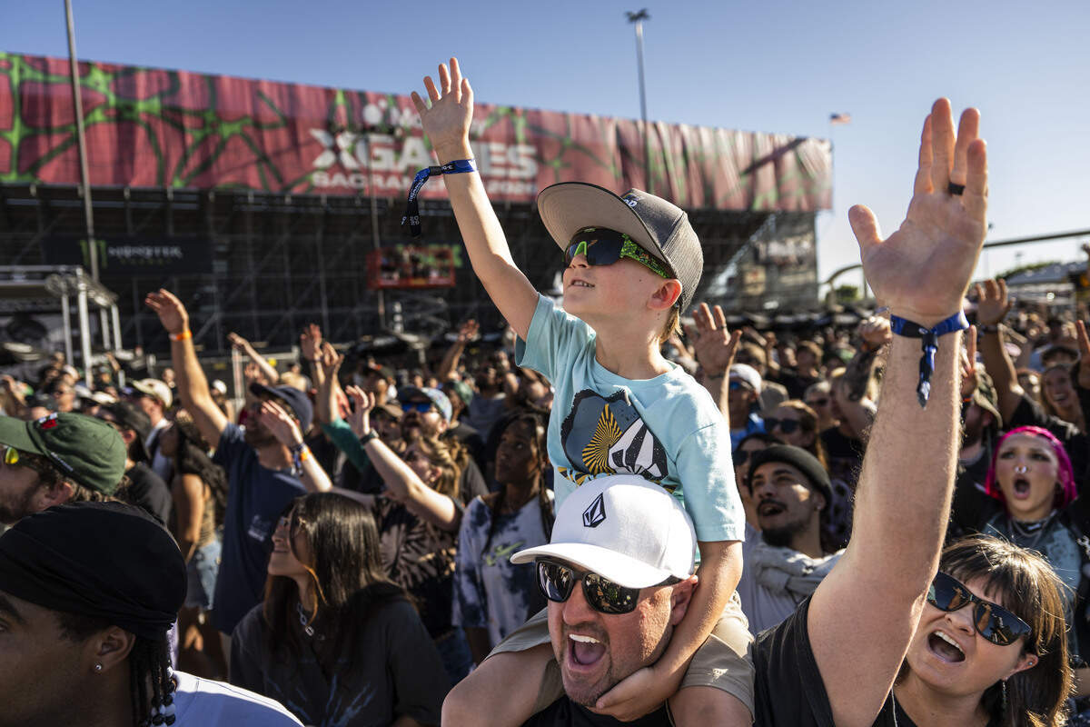 Matt Smith, of Sacramento, holds his son Colton on his shoulder as they attend the MoonPay X Games competitions on Friday, June 26, 2026.