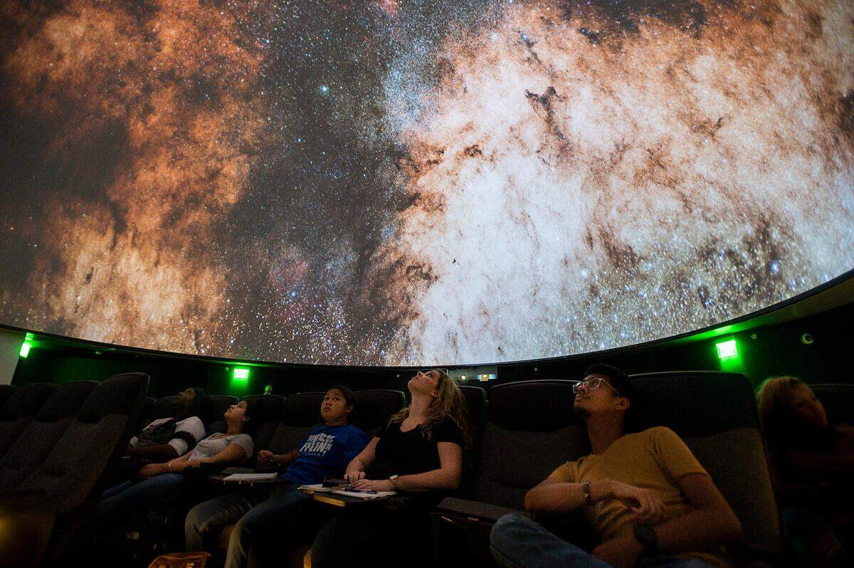 16. Students of astronomy professor Kyle Watters view the solar system during his first astronomy class in the new planetarium at Sacramento State on Monday, Aug. 26, 2019.