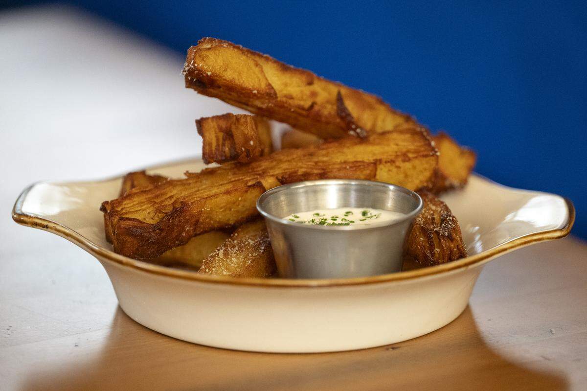 The pavé fries, topped with sour cream and onion powder and served with créme fraîche, at Good Neighbor in Sacramento on Thursday, Jan. 29, 2026.