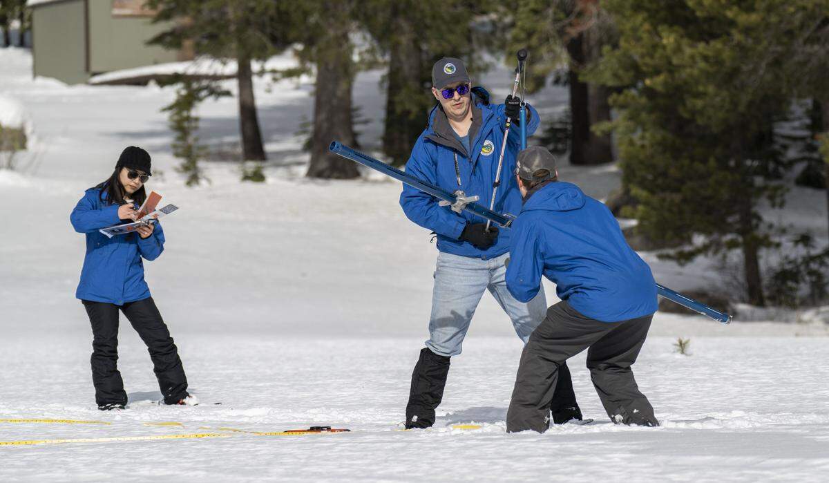 California Department of Water Resources hydrometeorologist Angelique Fabbiani-Leon, left, and engineers Jacob Kollen and Anthony Burdock take the season's first snow survey measurements at Phillips Station in El Dorado County on Tuesday.
