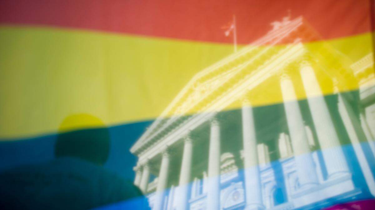 The California Capitol building is visible through an LGBT flag during a rally in celebration of the Supreme Court decision regarding gay marriage on June 26, 2013.