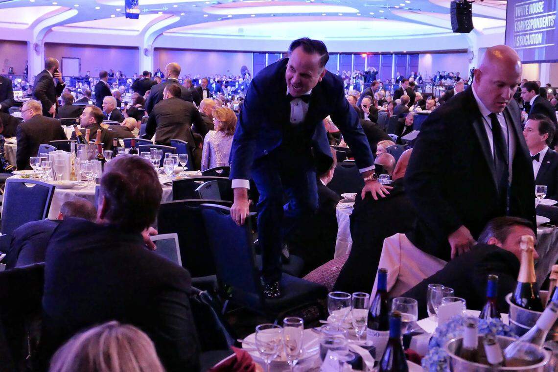 WASHINGTON, DC - APRIL 25: White House Deputy Chief of Staff Dan Scavino jumps over a chair after an incident at the annual White House Correspondents Association Dinner April 25, 2026 in Washington, DC. According to reports, President Donald Trump, along with other government officials, were evacuated from the Washington Hilton after what sounded like gun fire. According to the FBI's Washington field office, a 'subject' is in custody. (Photo by Chip Somodevilla/Getty Images)