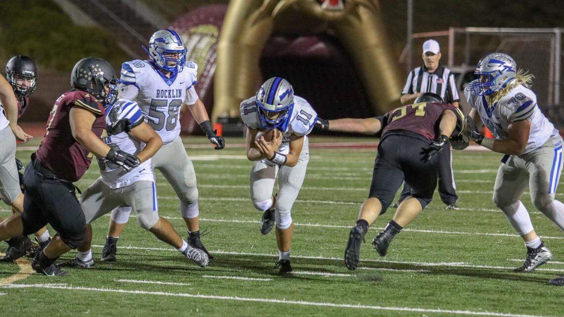 Rocklin quarterback Richie Watts runs through a gap in the line during his team’s 27-14 win Friday over Whitney.