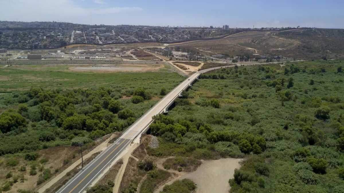 A section the Tijuana River in south San Diego County with the U.S.-Mexico border in the background. A nonprofit’s report lists the binational waterway as the ninth-most endangered river in America.