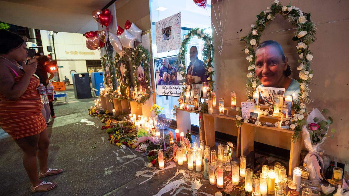 A photo of Melinda Davis, right, joins pictures of other victims Wednesday, April 6, 2022, amid the growing memorial on 10th and K streets for the victims of the shooting early Sunday morning that left six people dead in downtown Sacramento. Davis, who was homeless, was caught in the crossfire.
