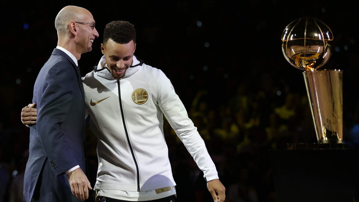 Golden State Warriors' Stephen Curry, right, is greeted by NBA Commissioner Adam Silver during a ring ceremony prior to a game against the Houston Rockets on Oct. 17, 2017, in Oakland. The Warriors have won three of the last four NBA titles.