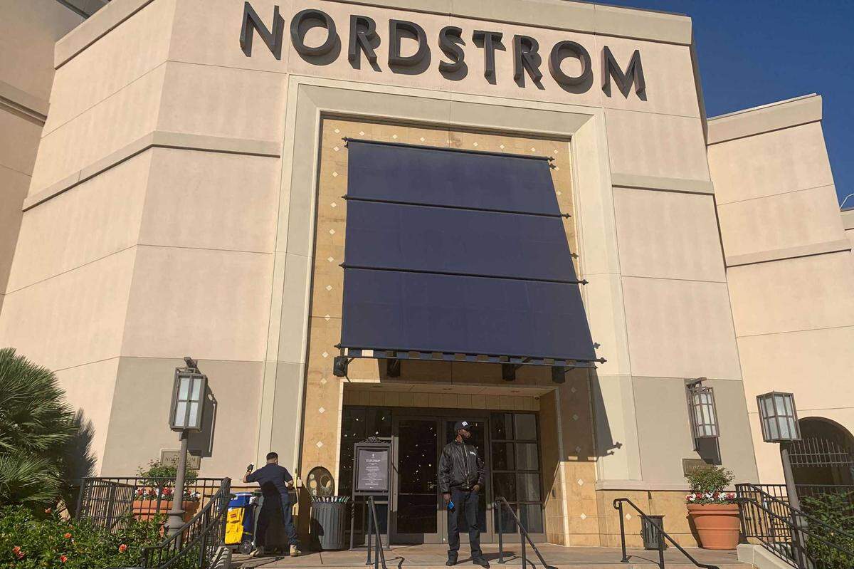 A security guard stands outside the Nordstrom store at The Grove retail and entertainment complex in Los Angeles, Tuesday, Nov. 23, 2021. Los Angeles police say a group of thieves smashed windows at the department store at the luxury mall late Monday, the latest incident in a trend of smash-and-grab crimes is part of a state trend. Thefts at Bay Area and Southern California stores has Sacramento-area law enforcement preparing for Black Friday to thwart similar brazen crimes over the holiday shopping season.