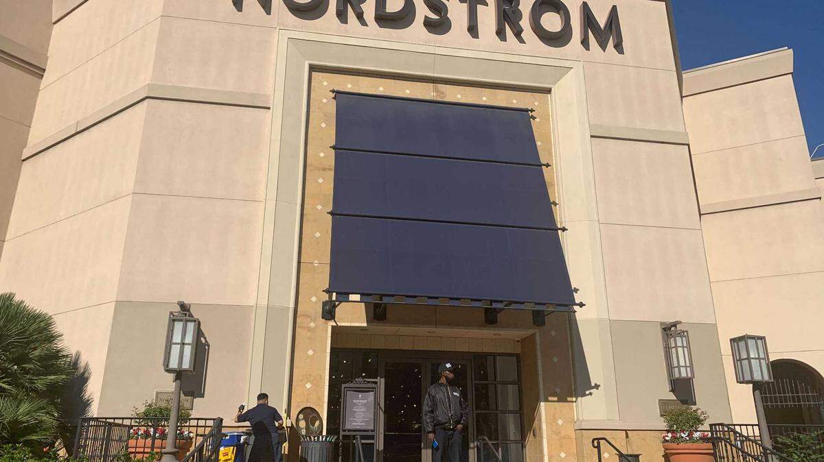 A security guard stands outside the Nordstrom store at The Grove retail and entertainment complex in Los Angeles, Tuesday, Nov. 23, 2021. Los Angeles police say a group of thieves smashed windows at the department store at the luxury mall late Monday, the latest incident in a trend of smash-and-grab crimes is part of a state trend. Thefts at Bay Area and Southern California stores has Sacramento-area law enforcement preparing for Black Friday to thwart similar brazen crimes over the holiday shopping season.