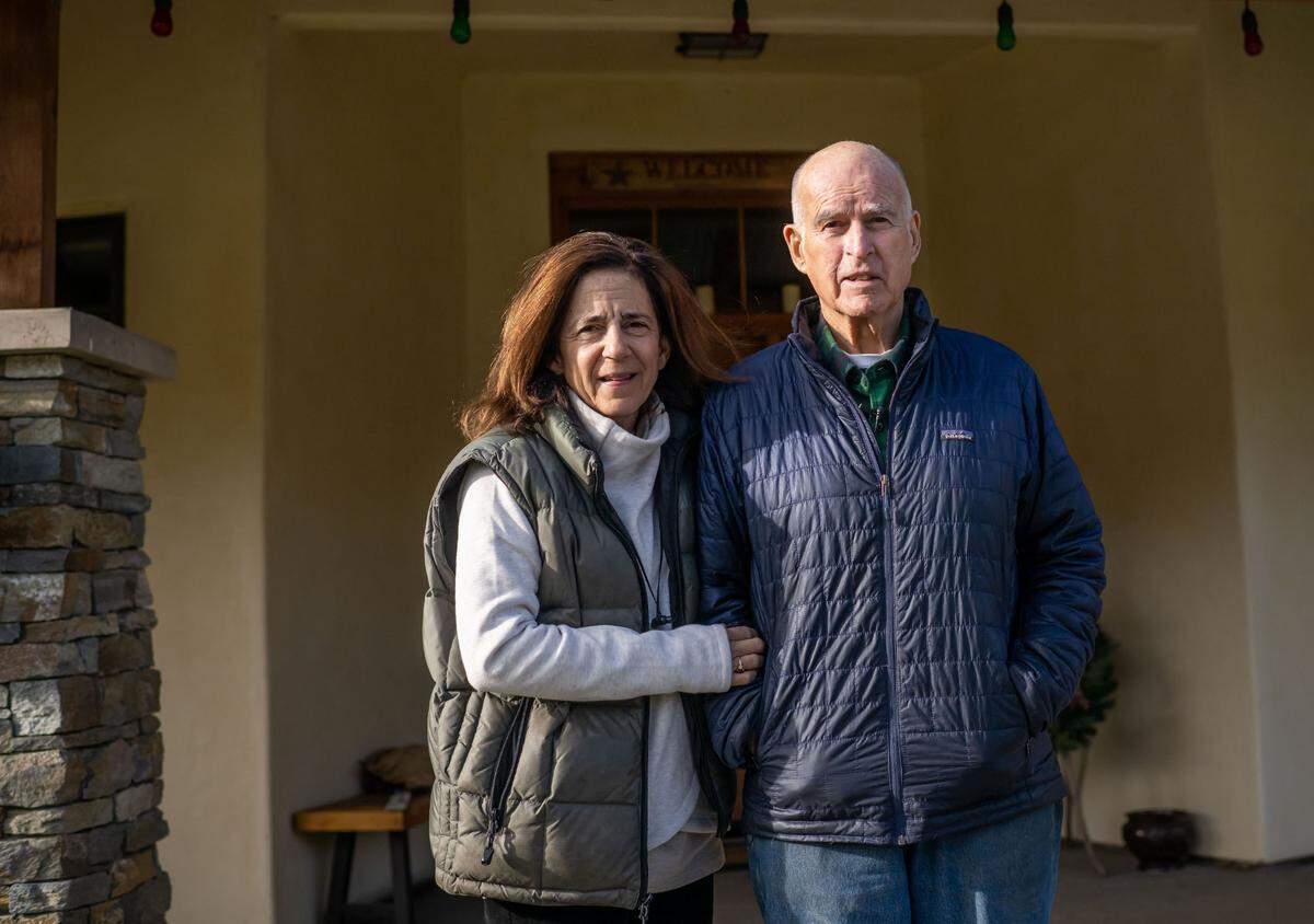 Former Gov. Jerry Brown, California’s longest-serving governor, and wife and former First Lady Anne Gust Brown stand in front of their home at their ranch in December.