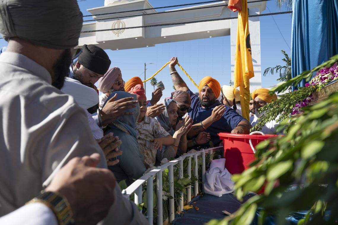 Offerings are brought to the main float during Nagar Kirtan, also known as the Sikh Parade, in Sutter County on Sunday.