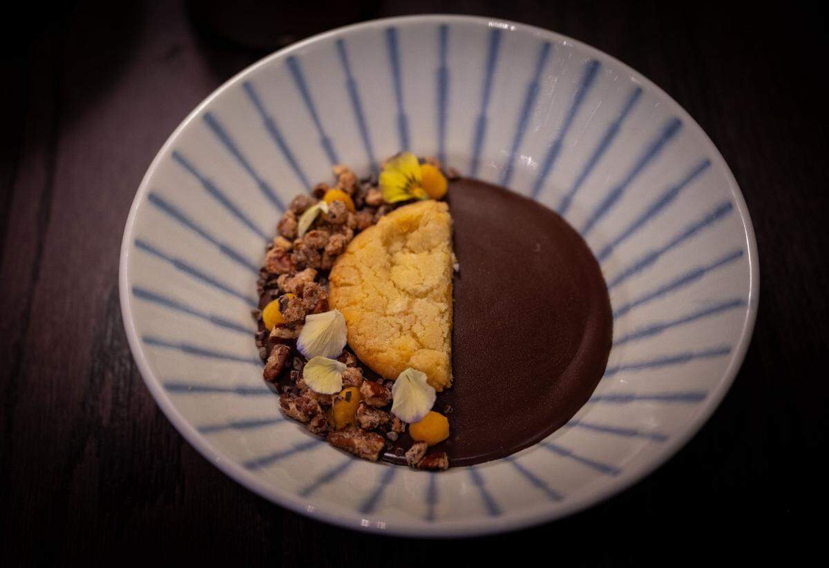 Vietnamese coffee mousse is served with chocolate ganache, salted egg custard and candied pecans at Chu Mai.