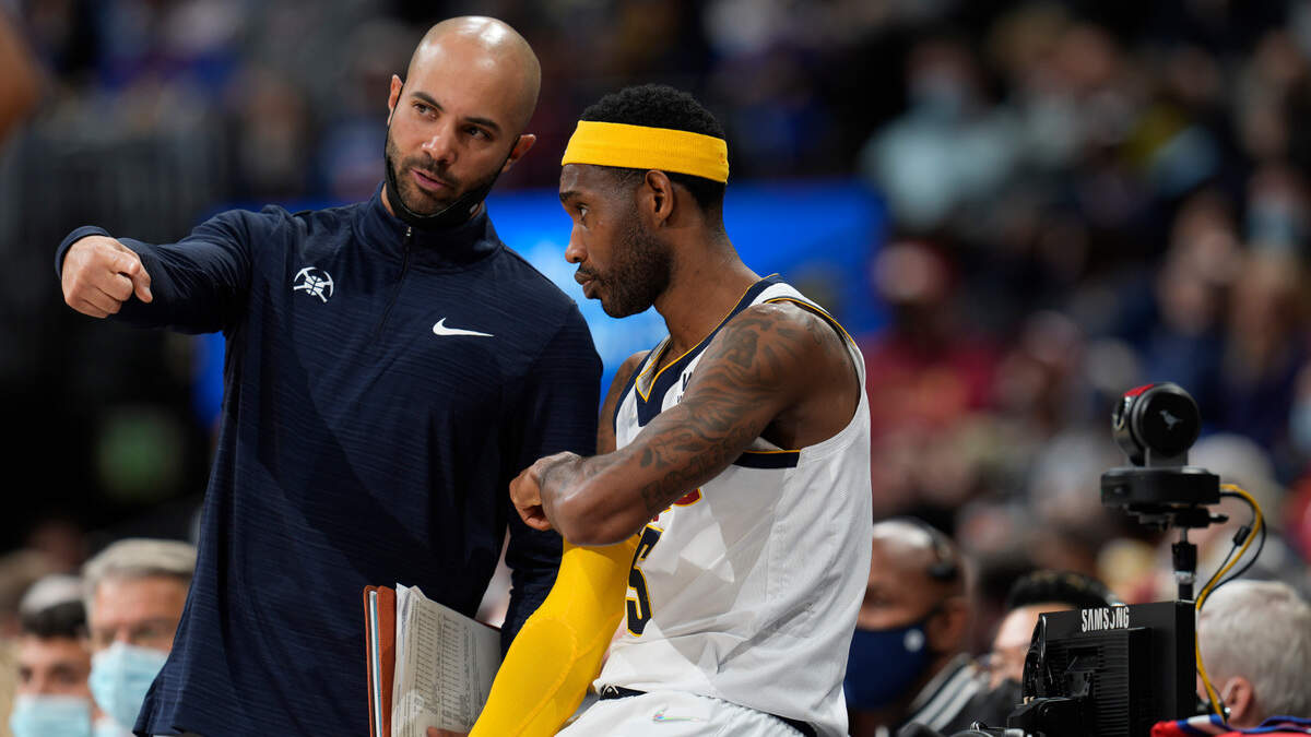 Denver Nuggets assistant coach Jordi Fernandez confers with Denver Nuggets forward Will Barton in the second half of an NBA basketball game Friday, Nov. 12, 2021, in Denver. The Nuggets won 105-96. (AP Photo/David Zalubowski)