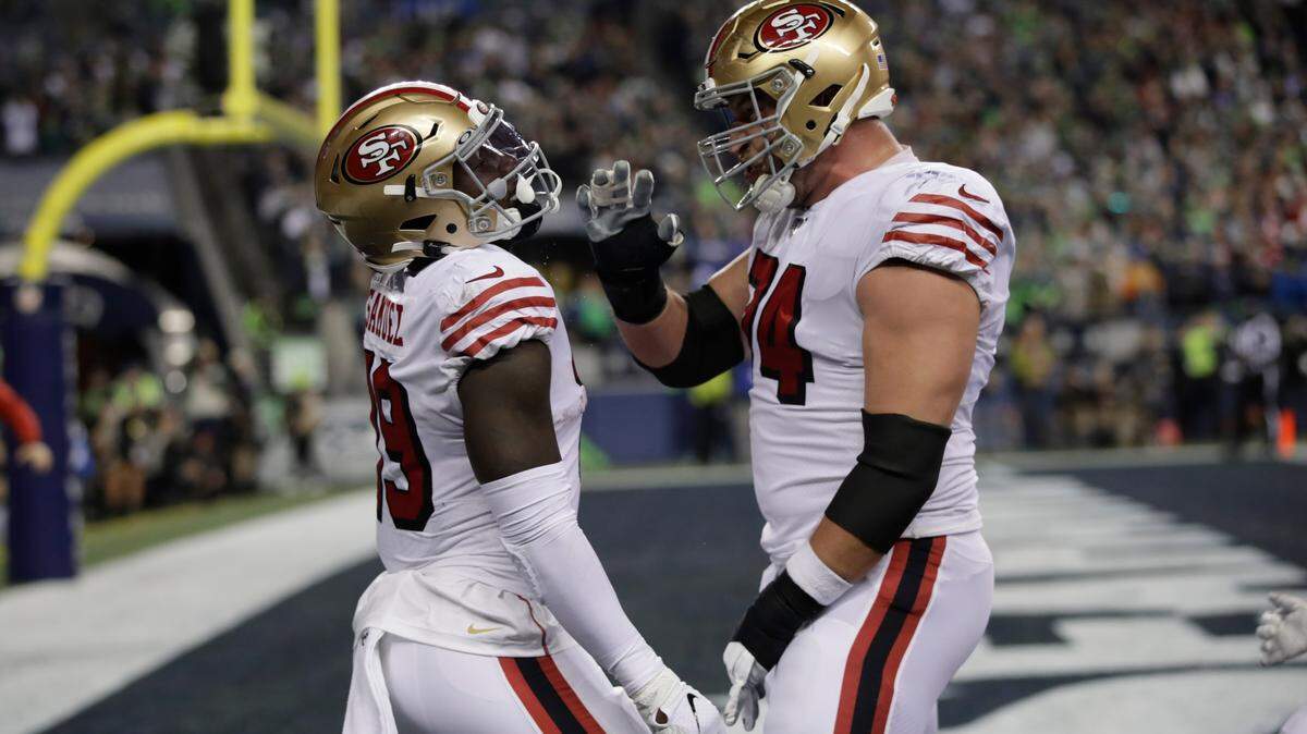 San Francisco’s Deebo Samuel is congratulated by Joe Staley on Samuel’s touchdown against the Seattle Seahawks.