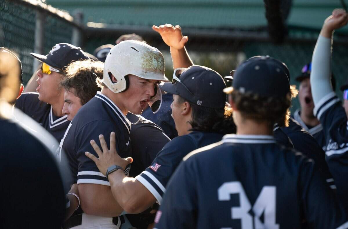 Casa Roble’s Carter Gustafson is greeted by teammates after scoring in the second inning against Twelve Bridges during a CIF Sac-Joaquin Section Division IV baseball section championship game on Wednesday at Sacramento City College.