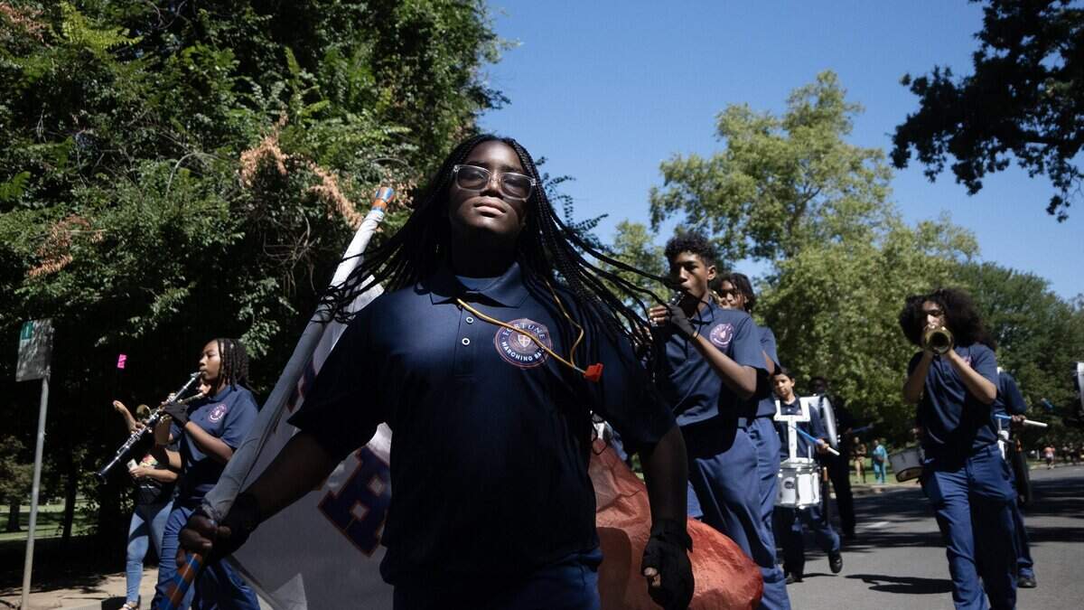 Members of the Rex and Margaret Fortune School of Education march during the parade during the Juneteenth event in Land Park on Saturday in Sacramento.