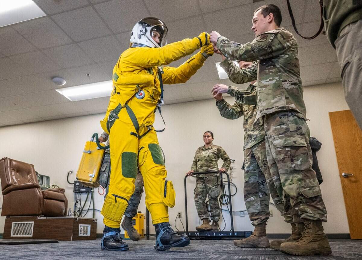 Capt. Blitz fist bumps Staff Sgt. Brandon Gomez after being dressed in a pressure suit used for pilots of the U-2 Dragon Lady reconnaissance aircraft at Beale Air Force Base earlier this month.