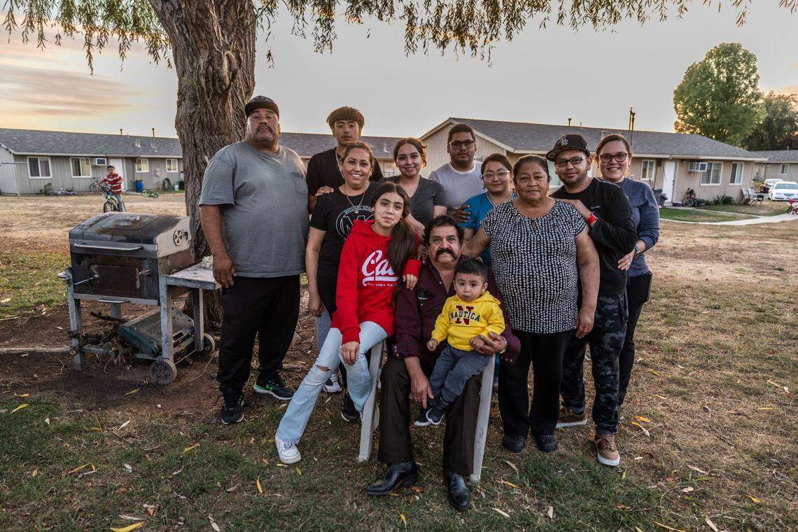 Karla Acevedo Perez sits for a photograph with her mother, siblings, uncles and grandparents at the Lodi migrant center in October. Four generations of the Perez family, starting during the Bracero Program, have worked as migrant farmworkers in California.