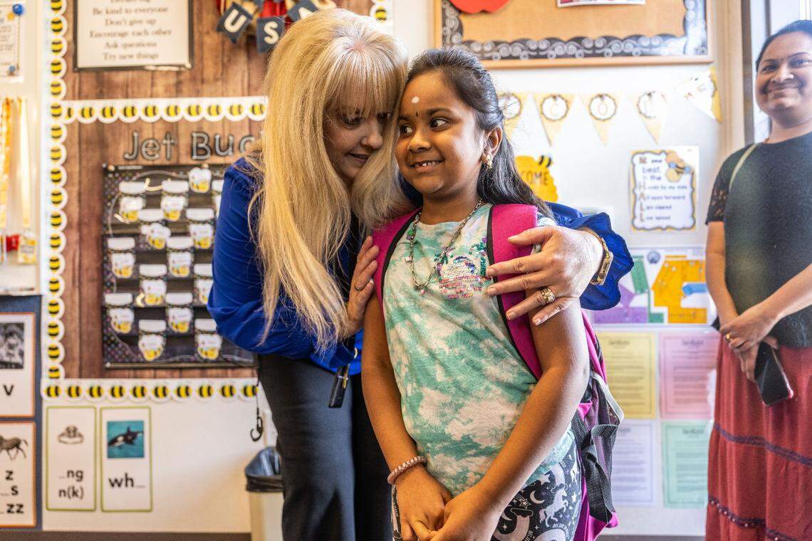 Principal Stacey Firpo welcomes second-grade student Jarnika Nagapande on the first day of school at Northlake TK-8 on Tuesday.