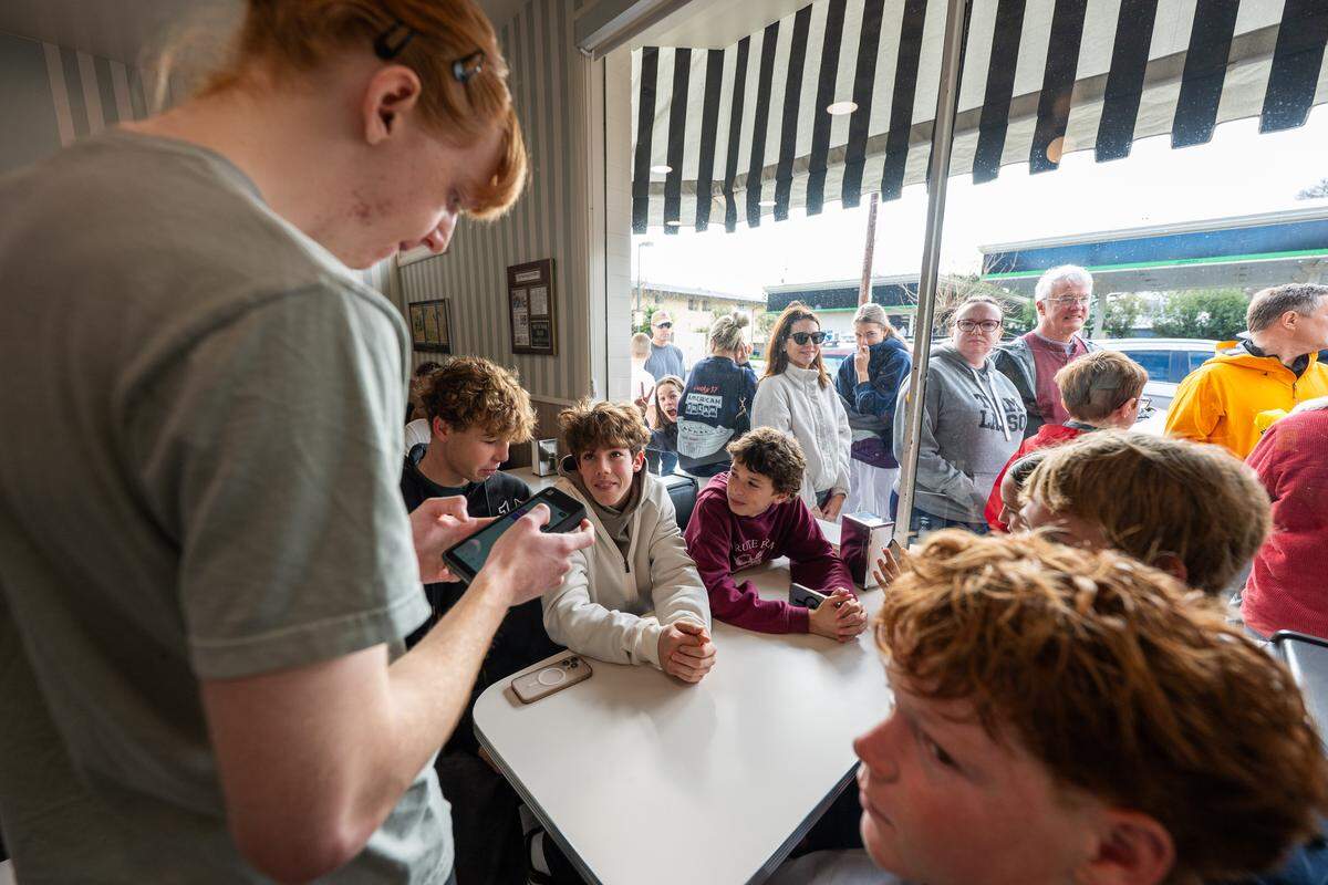 Server Kuyper Holland takes down an order at Vic’s Ice Cream in Sacramento during its reopening on Saturday.