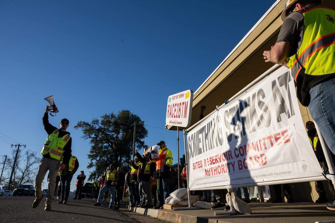 Nor Cal Carpenters Union member Alex Hampton shouts into a bullhorn during a protest outside a Sites Reservoir Project meeting in Maxwell as officials vote to finalize the contract to build the reservoir with Barnard Construction on Friday. The union opposes the selection of the out-of-state contractor, citing concerns about safety and budget overruns.