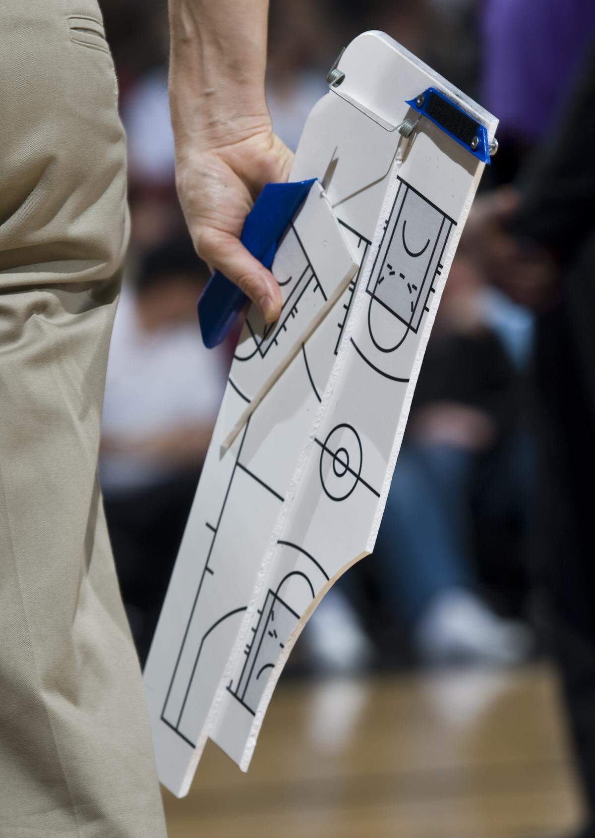 The Sacramento Kings athletic trainer Pete Youngman carries a broken game board that was slammed to the floor as the Kings started to lose the game against the Chicago Bulls on Friday, Jan. 30, 2009.