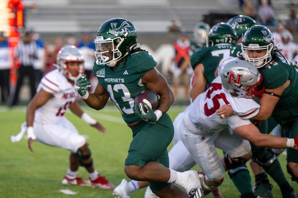 The Sacramento State Hornets running back Zeke Burnett (13) runs through the Nicholls State Colonels defense for a touchdown in the second quarter on Saturday at Sacramento State.