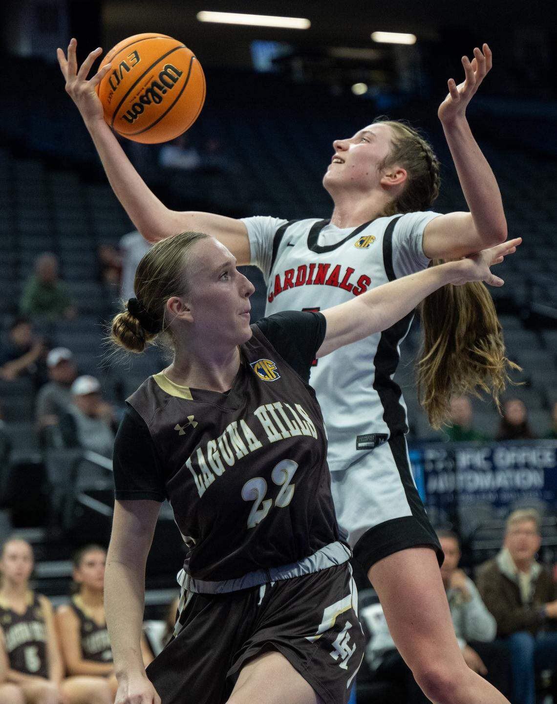 Woodland Christian’s Sofia Sorbello battles for a rebound with Laguna Hills’ Cameron McDermott during the 2026 CIF State Basketball Championship at the Golden 1 Center on Friday in Sacramento.
