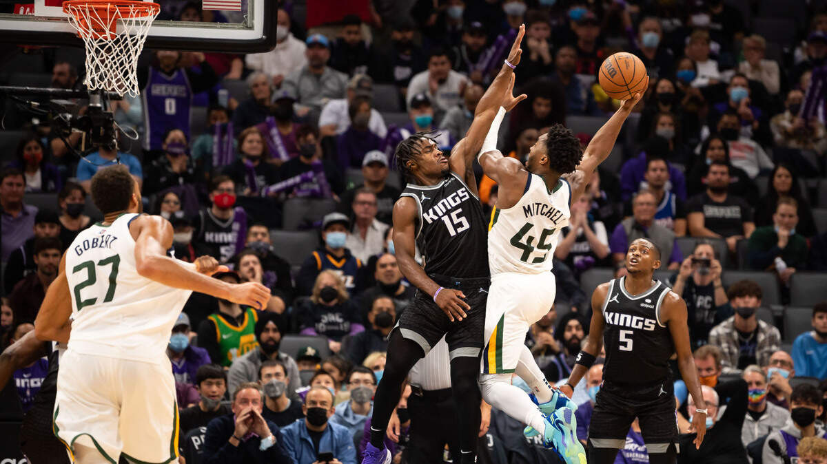 Sacramento Kings guard Davion Mitchell (15), left, defends against Utah Jazz guard Donovan Mitchell (45) during the second half of their NBA regular season home opener Friday, Oct. 22, 2021, at Golden 1 Center in downtown Sacramento.