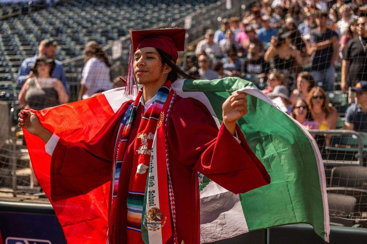 Carlos Zamudio holds a Mexican flag during the C.K. McClatchy commencement ceremony on Tuesday.