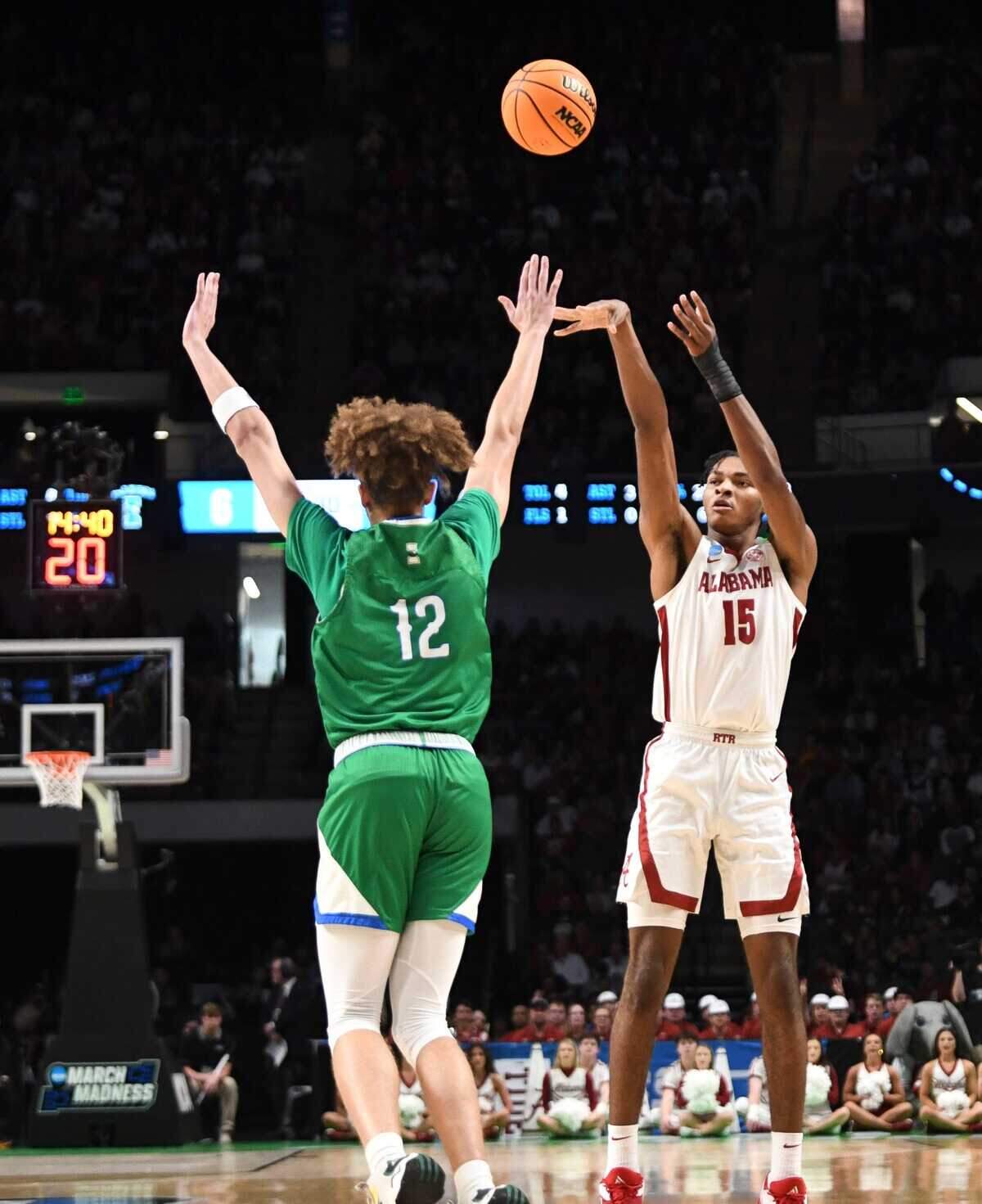 Alabama forward Noah Clowney (15) shoots a three over Texas A&M Corpus Christi forward Owen Dease (12) in the first round of the NCAA Tournament on March 16, 2023, at Legacy Arena in Birmingham, Alabama.